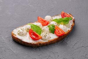 Caprese bruschetta toasts with cherry tomatoes photo