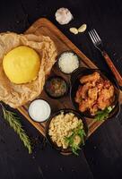 Traditional Romanian hominy porridge on a wooden tray photo