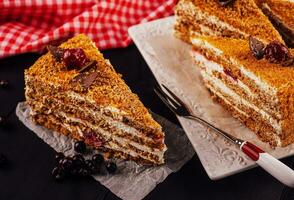 Carrot cake with walnuts and cherry photo