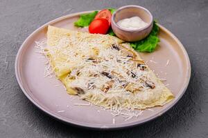 pancakes with mushrooms and parmesan on plate photo