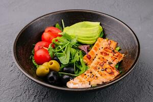 salad with grilled salmon, avocado, tomatoes with arugula photo