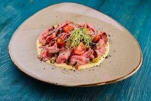 fried cured and sliced veal tongue with mashed potatoes photo