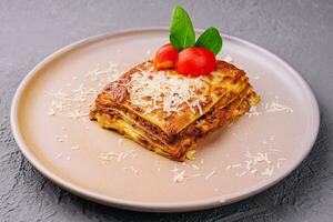 Traditional lasagna with bolognese sauce topped photo