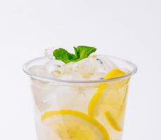 seltzer cocktail with orange, mint and ice cubes photo