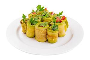 Plate with tasty zucchini rolls and tomatoes on plate photo