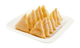 triangular pancakes with meat on plate photo