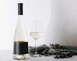 Bottle of white wine with glass photo