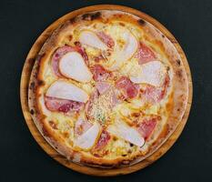Delicious meat pizza with salami, ham and cheese photo