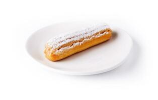 Delicious french dessert Eclair on plate photo