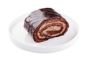 Chocolate roll with cream on a white plate photo
