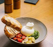 burrata cheese with artichokes and pesto sauce photo