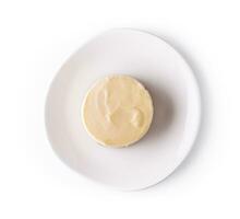Lemon meringue tart on white plate top view photo