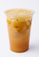 Iced caramel coffee covered with whipped cream in plastic glass photo