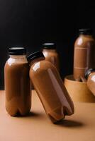 chocolate smoothies milkshake in bottles on black and brown background photo