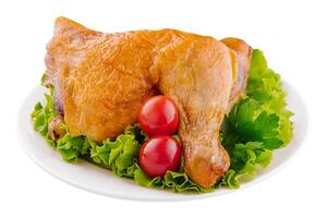 Smoked chicken lies on a green lettuce leaf photo