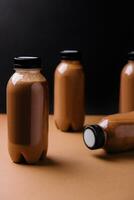 chocolate smoothies milkshake in bottles on brown background photo