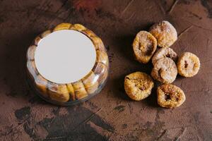 Dried figs in round plastic packaging on top view photo