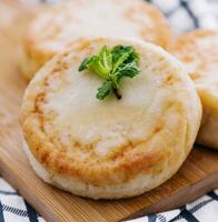 Cottage cheese pancakes on board close up photo