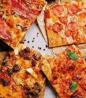 Tasty pizza on the wooden background photo