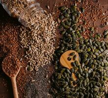 Different types of grains and seeds on shabby wooden photo