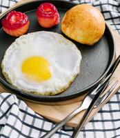 fried egg with salted red fish in a pan with coffee photo