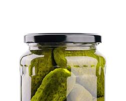 A glass jar of tasties canned cucumbers on white background photo