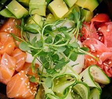 A bowl of salmon poke with avocado photo