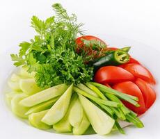 Vegan plate of fresh sliced cucumbers, green onions and cherry tomatoes photo