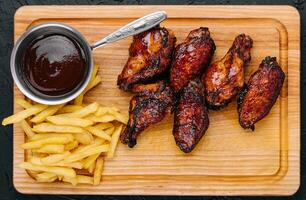 Fried glazed chicken wings and legs photo