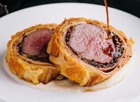 Fillet wellington in puff pastry on plate photo