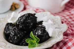 Cup of tea with prunes close up photo