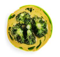 Pumpkin cream soup with broccoli on plate photo