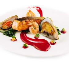 dish with salmon, shrimps, mussels and seaweed photo