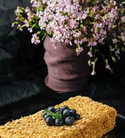 Napoleon cake decorated with blueberries and mint photo