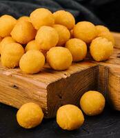 Tasty cheese balls on a wooden Board photo