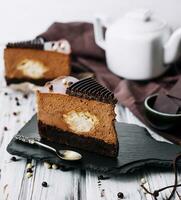 A piece of chocolate cake with tea photo