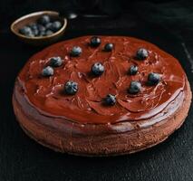 Delicious chocolate cake decorated with fresh blueberries photo