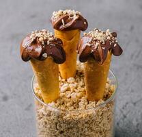 waffle cones with hazelnuts and chocolate cream photo