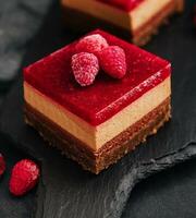 Delicious chocolate mousse cake with raspberries jelly photo