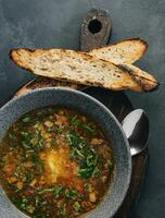 Onion soup with roasted bread top view photo