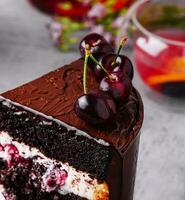 Chocolate cake with cherries and chocolate cream photo