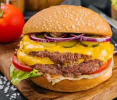 Fresh tasty burger on wooden board photo