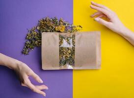 Paper bag with dry loose leaf tea photo