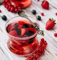 Jelly with fresh berries on wooden table close up photo