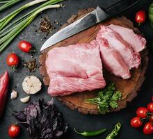 Raw pork neck meat cuts with spices photo