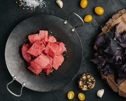 Raw meat is cut into pieces top view photo