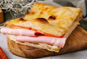 Fried pita bread with ham close up photo