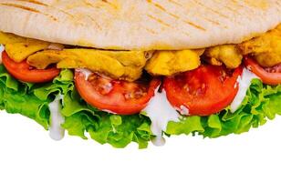 Doner kebab - fried chicken meat with vegetables in pita bread photo