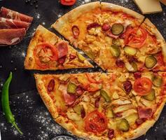 pizza with sausage, ham and chicken photo