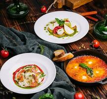 different types of italian dishes on a large wooden table photo